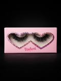 Pink heart-shaped box containing false eyelashes with 'Radiant' branding on a black background.